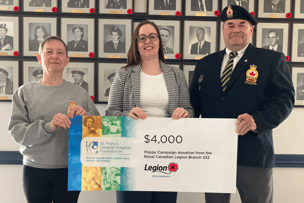 Pictured: Branch Poppy committee member Margret Nodwell (left) and Poppy Chair Gary Bender (right) with Kourtney Parker, Director of Development at SMGH Foundation (centre) in front of the wall of past Presidents.